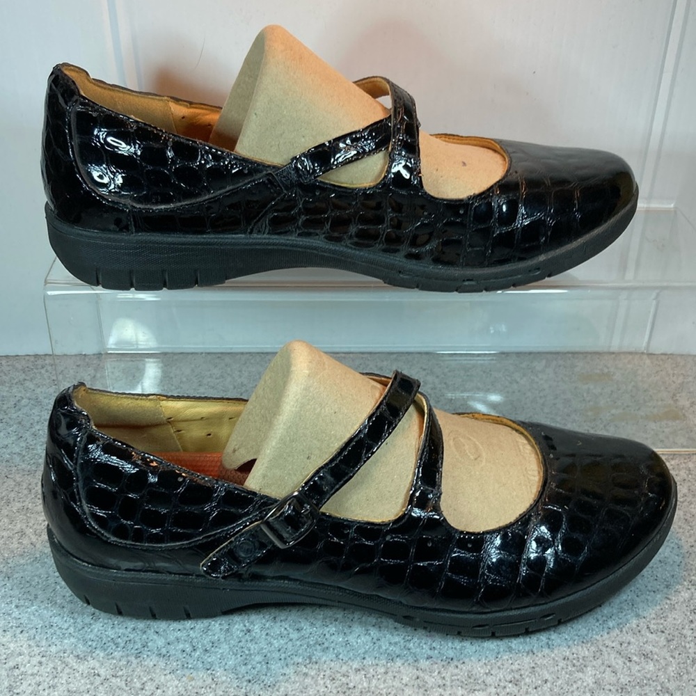 9 Clark’s unstructured black faux alligator‎ skin Mary Janes with double straps.